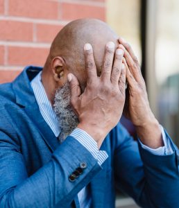 man holding his head in his hands