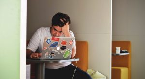 stressed out male working on laptop