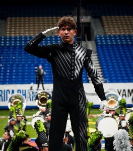 Drum major Aidan Veith salutes to the crowd at the conclusion of the Reagan band’s 2023 finals performance at the Bands of America San Antonio Super Regional.