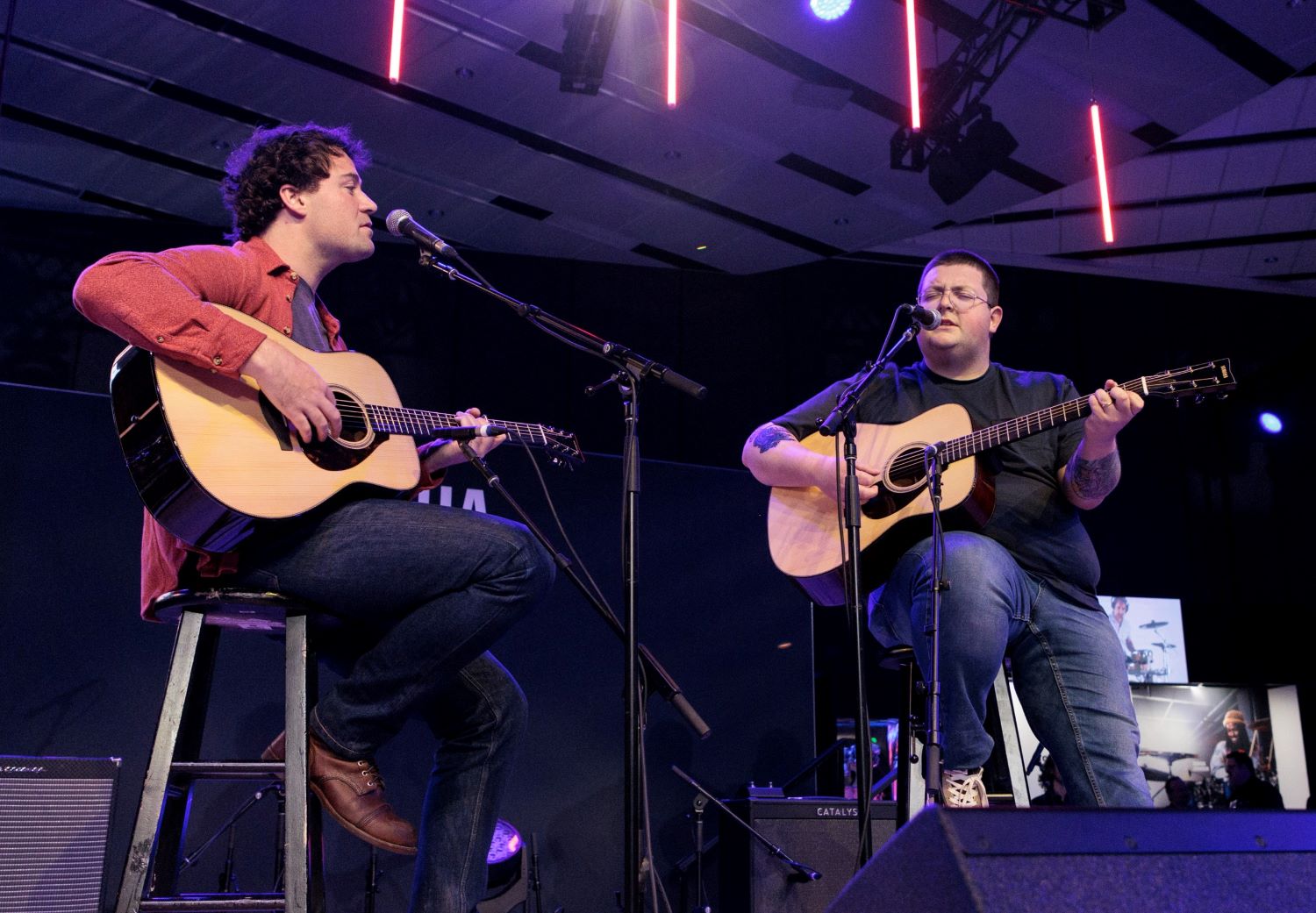 NAMM-2023-Recap-body-image-7 Two men playing guitars on stage.
