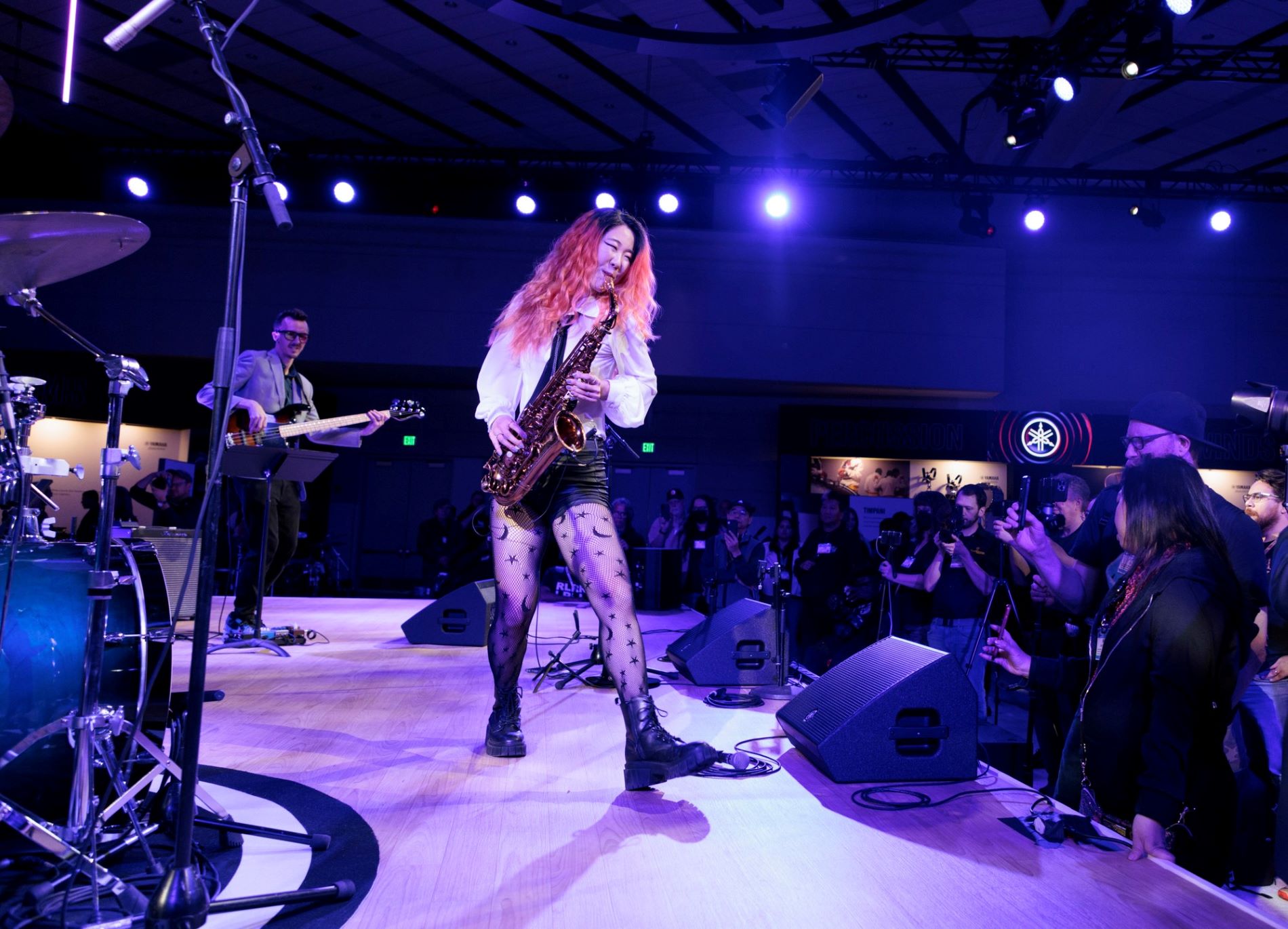 NAMM-2023-Recap-body-image-9-resize Woman playing a saxophone on stage.