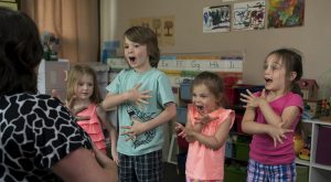 four students performing for students