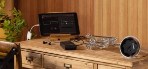A tablet and a trumpet, and an electronic box on a table.