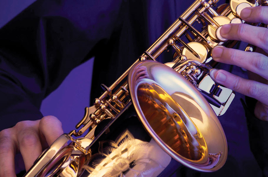 Closeup of someone's hands playing saxophone.