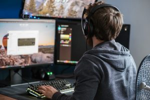man working computer and multiple screens
