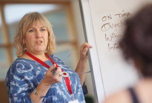 teacher standing by white board