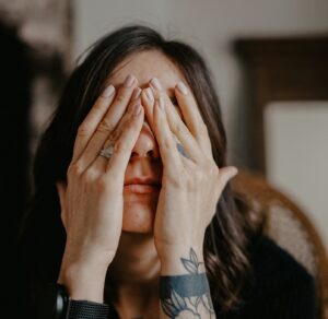 frustrated woman with hands on her face