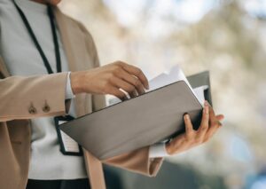 person holding an open three-ring binder