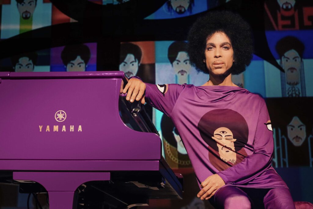 Prince-sitting-at-piano Prince sitting at his purple piano.