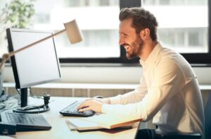 teacher at desk working on computer