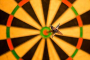 dart board with a dart in the bull's eye