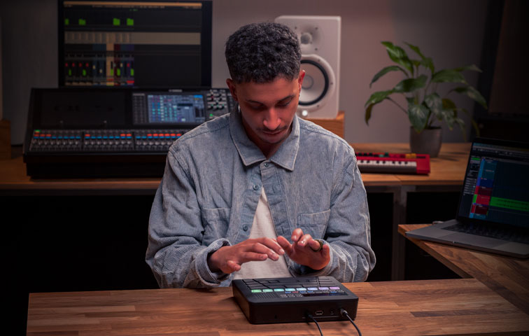 Man working on small keyboard.