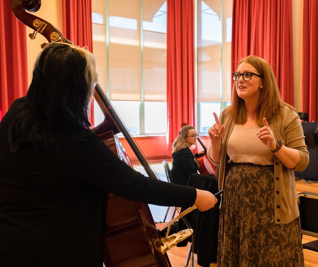 music educator watching student play the bass