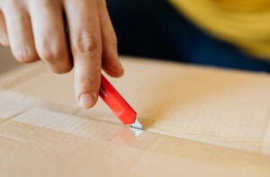 closeup of someone using a box cutter