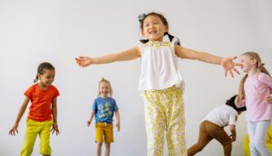 elementary school students jumping and dancing