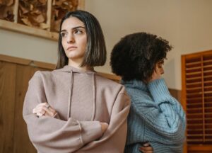 two women turning their backs on each other