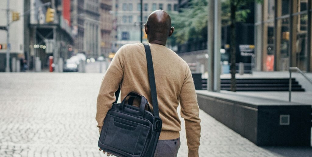 man walking with a messenger bag