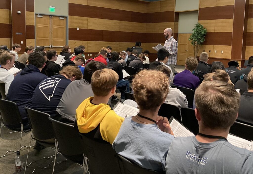 music teacher speaking in front of group of students