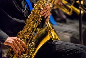 Close up of man playing saxophone in a band