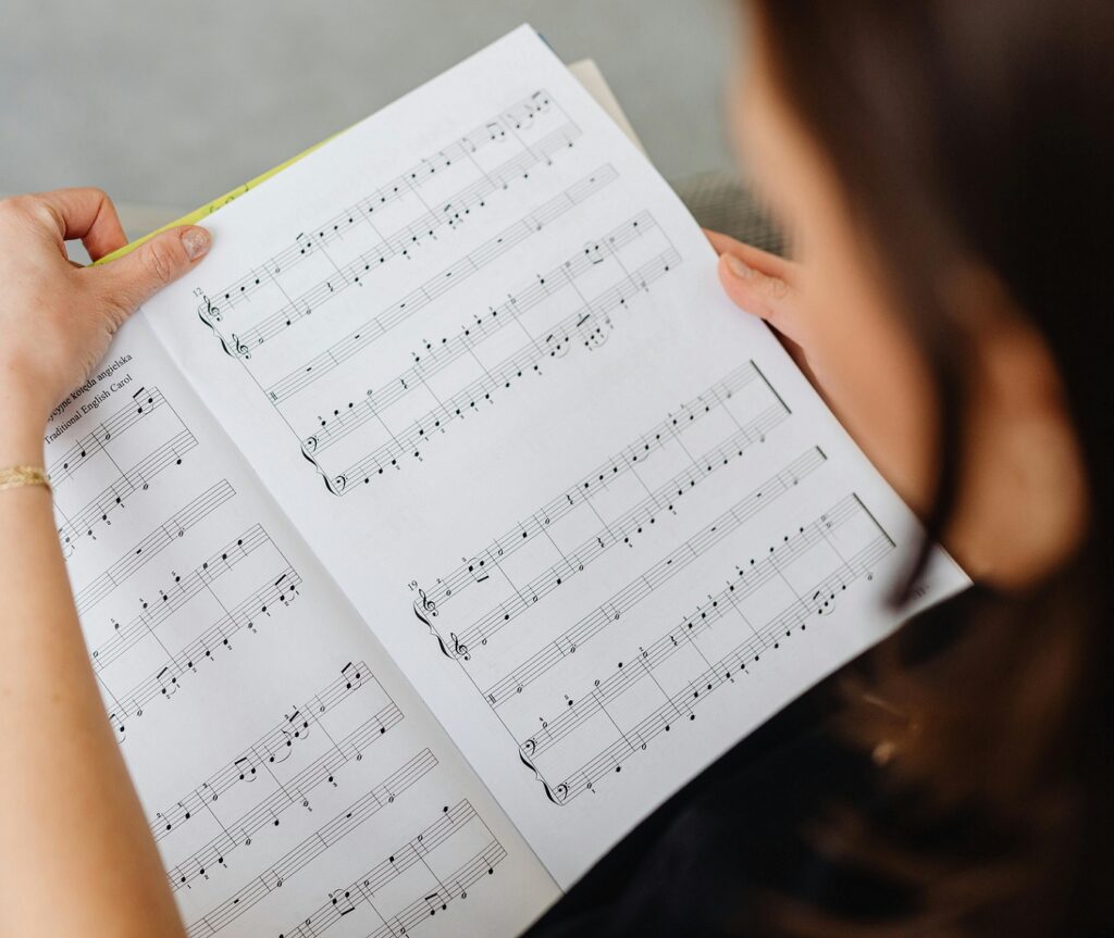 female teacher looking over musical score