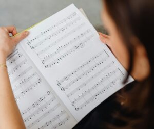 female teacher looking over musical score 