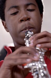 male student playing the oboe