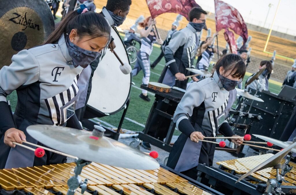 two percussionists performing on field