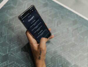 hand holding phone with ChatGPT open on screen 