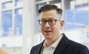 man with glasses speaking 