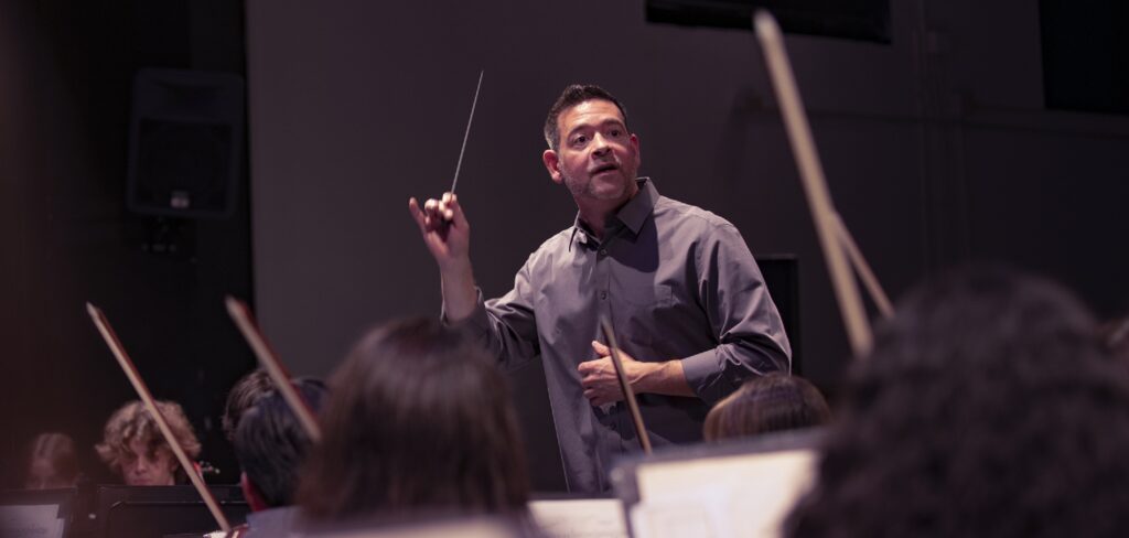 music educator conducting rehearsal