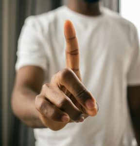 person holding up one finger